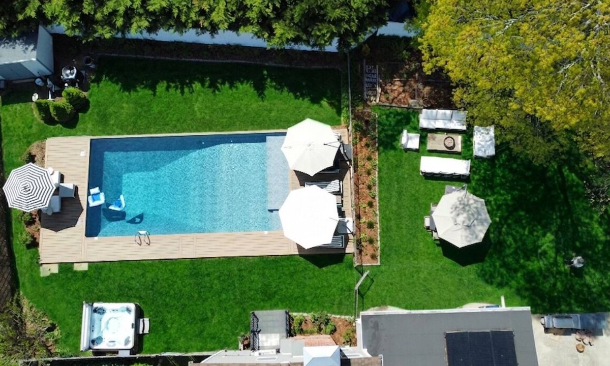 Brookhaven House | Chic Retreat: Hot Tub, Heated Pool, Sunroom