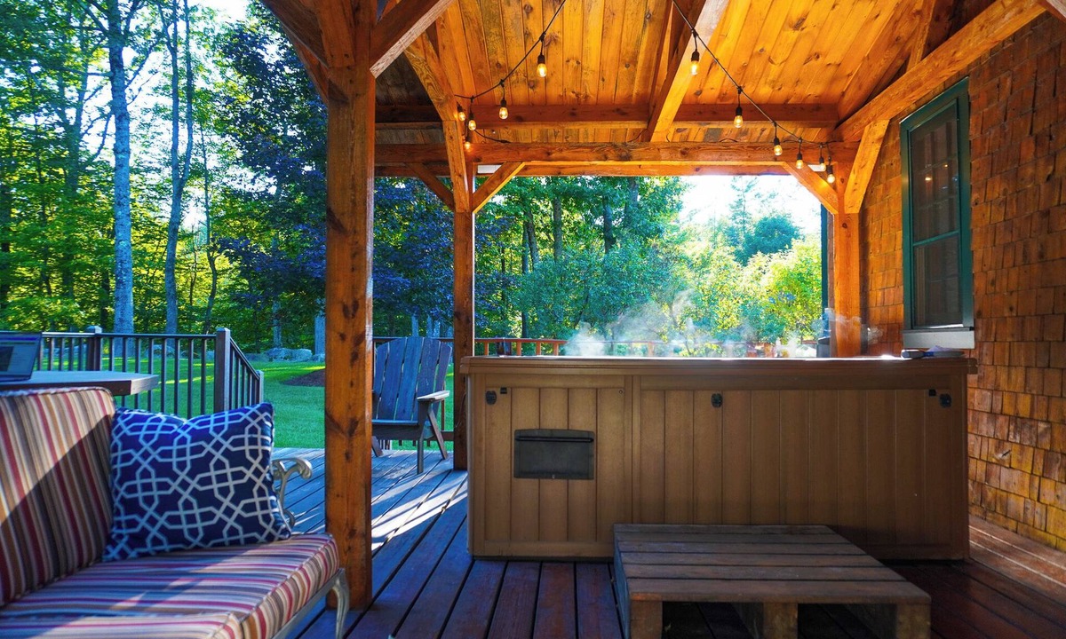 Holderness House | Escape to Central Escape’s 2-bedroom option, perfectly located in New Hampshire’s Lakes Region. Enjoy a private year-round hot tub, spacious backyard with yard games, and easy access to downtown Meredith, Squam Lake, and summer concerts.