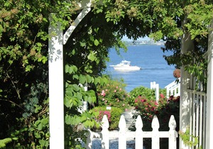 Old fashioned designer front porch living by the sea with expansive water views.
