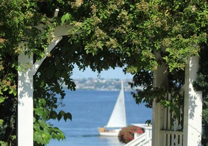 Old fashioned designer front porch living by the sea with expansive water views.