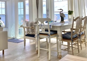 Old fashioned designer front porch living by the sea with expansive water views.