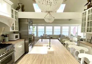 Old fashioned designer front porch living by the sea with expansive water views.