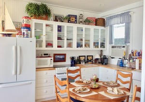 Old fashioned designer front porch living by the sea with expansive water views.