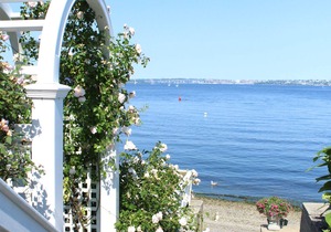 Old fashioned designer front porch living by the sea with expansive water views.