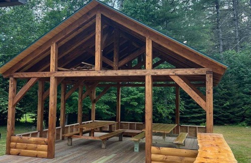 Sunday River Area House | Beautiful log cabin with nearby skiing, large living spaces, and outdoor patio