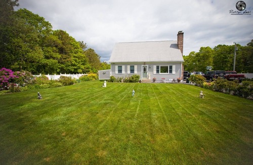 East Falmouth House | Cheerful residential home with beautiful outside area with heat swimming pool.