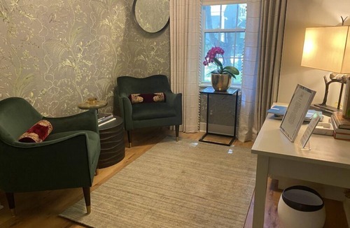 Lenox Bed & Breakfast | Elegant Carriage House room with a queen bed and private patio.