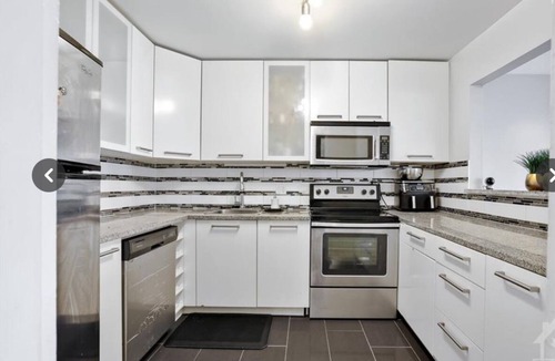 Ottawa Division Condo | Fully furnished bedroom in a cozy, modular home.