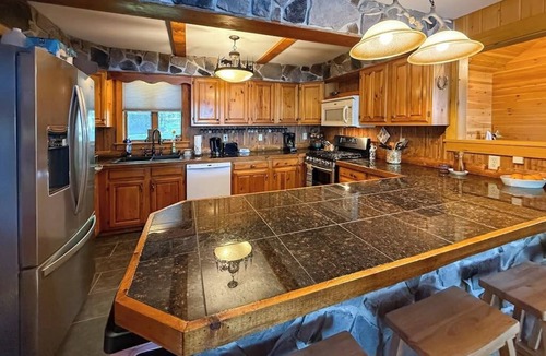 Rome House | Inviting Lakeside Home with direct dock access, patio seating, and gas fireplace