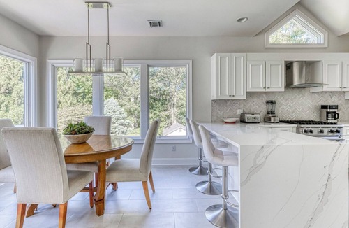 Northwest Harbor House | Modern, coastal-style home with flooding natural light, a private pool, a.
