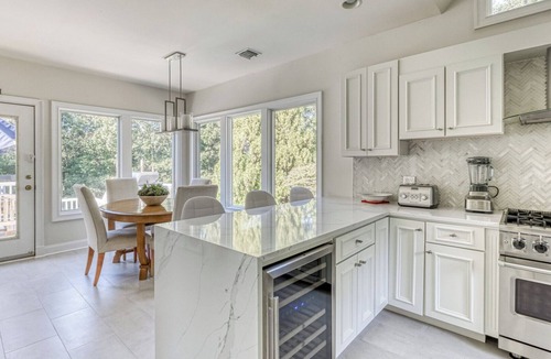 Northwest Harbor House | Modern, coastal-style home with flooding natural light, a private pool, a.