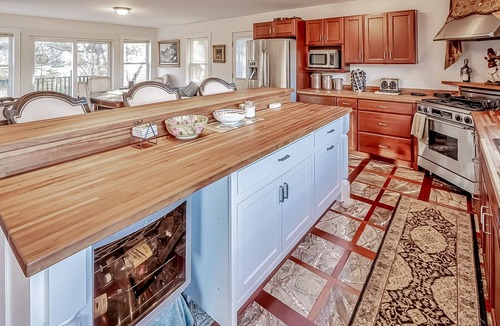 Belfast House | Ornate lake view home with wraparound deck, dock access & W/D
