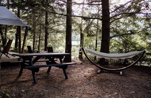 North Woodstock RV Rental | Safari Tent Site 6 | 1 Queen Bed & 1 Twin Bed | Pond View
