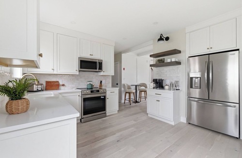 Kennebunk Apartment | Seaside luxury meets unbeatable location. This stylish 2BR/2BA retreat is steps from Dock Square KPT's restaurants, shops, and galleries, and includes beach gear and a private fire pit.