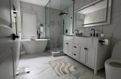 Woodbury House | Sleek&Serene:Fully Furnished Home w/Freestanding Tub, Marble Tile & Cozy Lounge