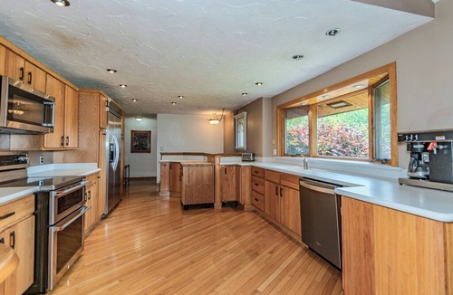Painesville Cabin | Spacious 5-bedroom lodge on 35 acres with pool house, pool, 2 ponds, waterfall!