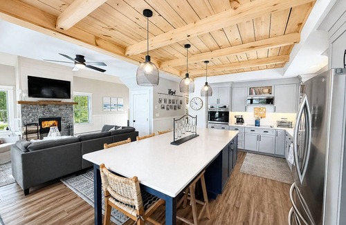 Ellsworth House | Stunning lakefront home with serene outside sitting area overlooking the water.