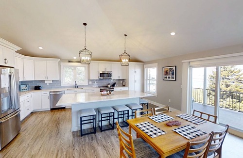 Mid-Coast and Islands House | This spacious home offers a FANTASTIC covered porch, perfect to spend your days gazing at the ocean!