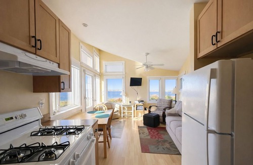 Mid-Coast and Islands Cottage | This sweet cottage offers a shared pebbly beachfront and gorgeous sunset views
