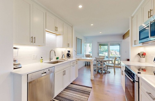 Gilford House | Tranquil lakeside retreat with beach access, pool, firepit, & lovely patio views
