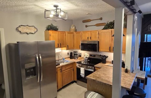 Weirs Beach Condo | Walk to Weirs Beach Boardwalk with Treetop Views of Lake Winnipesaukee!
