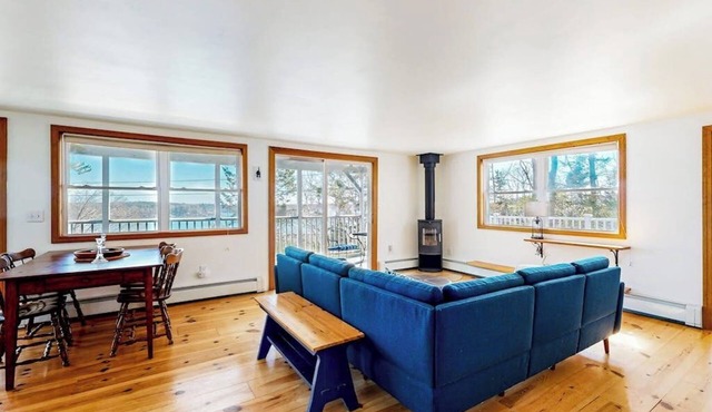 Dog-friendly river-view home with wood stove, deck, patio, dock, beach, grill