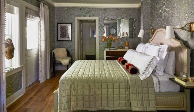 Elegant Carriage House room with a queen bed and private patio.