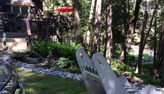 PARADISE OVERLOOKING THE BUBBLING CREDIT RIVER SURRONDED BY LUSH MATURE GARDENS