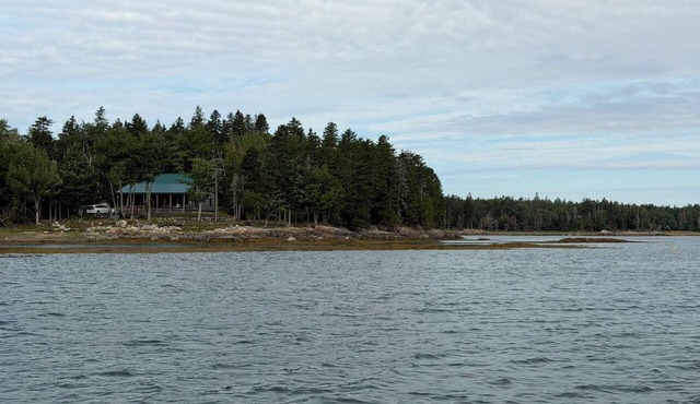 Shoreline solitude, rustic, nestled between evergreens and Pigeon Hill Bay
