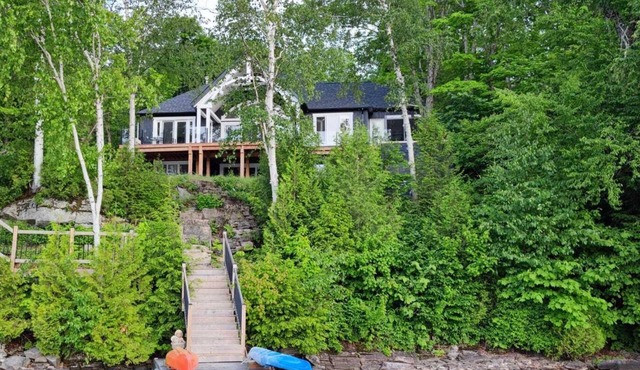 Spectacular new 4 season cottage on pristine Kennisis Lake! Sauna and hot tub!