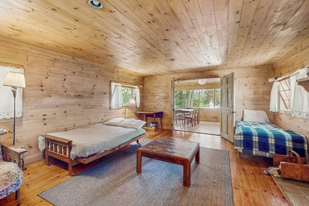 Charlotte Cottage | Classic lakefront cabin w/screened-in porch & mountain views - dogs-friendly